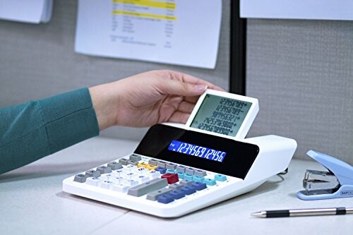 Person using a printing calculator with paper roll